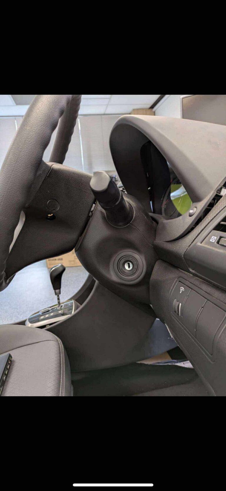 Steering column with the ignition barrel exposed during a lock repair