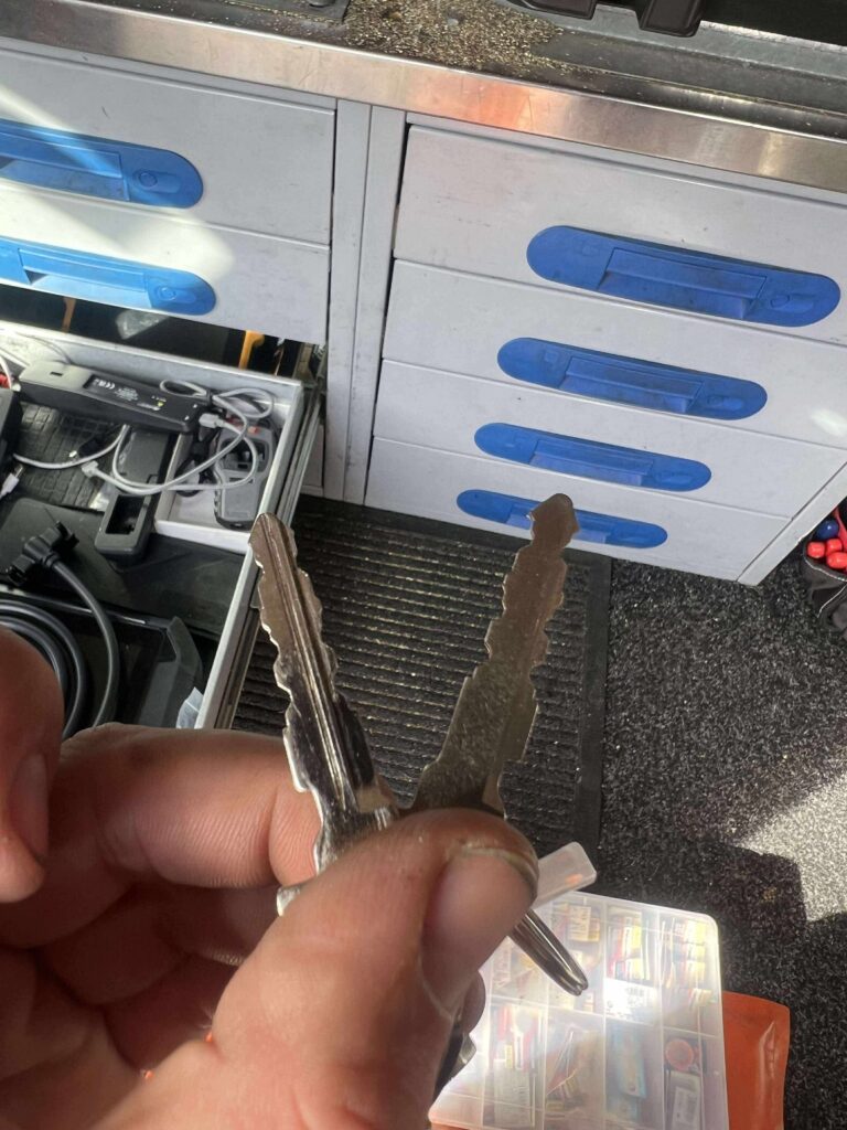 Cut keys held inside an Alchin mobile locksmith van fitted with key-cutting drawers and equipment